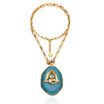 Colar Camila Klein com corrente dourada e pingente oval em pedra natural azul, com detalhe central em metal dourado. A peça combina cores e texturas orgânicas em um design autoral, sofisticado e vibrante, inspirado na leveza do verão. Ideal para compor produções elegantes e cheias de personalidade, valorizando a beleza singular das pedras naturais.